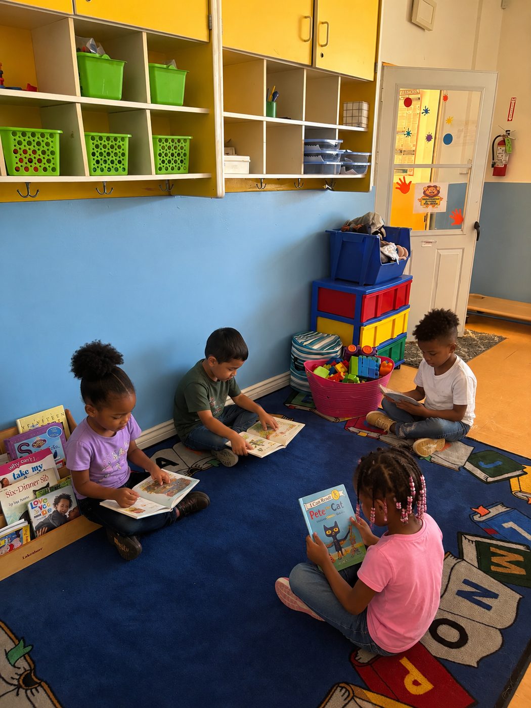 Children reading picture books on the reading carpet