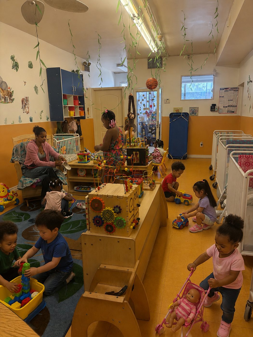 Toddlers exploring toys with a caregiver